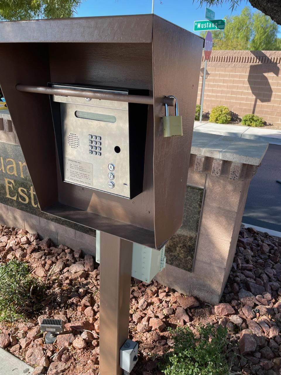 Telephone entry call box with keypad in a protective housing at a gated community entrance